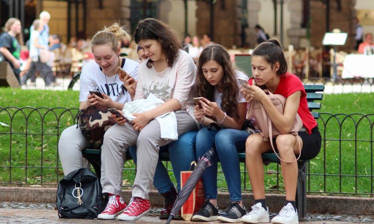 4 adolescentes qui regardent leur cellulaire